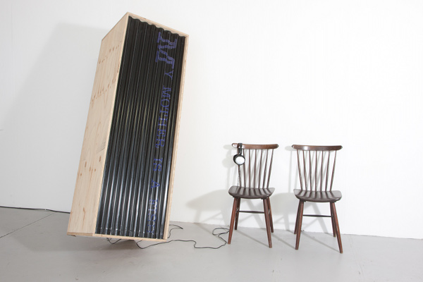 Gallery 1: Installation shot of<em> My Mother is a Fish </em> (2010), 1min 38sec audio, 2 chairs, William Faulkner’s novel <em>As I Lay Dying</em>, plywood, corrugated plastic, Gorilla Tape, led lights by James Merrigan; courtesy Six Memos” width=”600″ /><br /><br>
<div class=